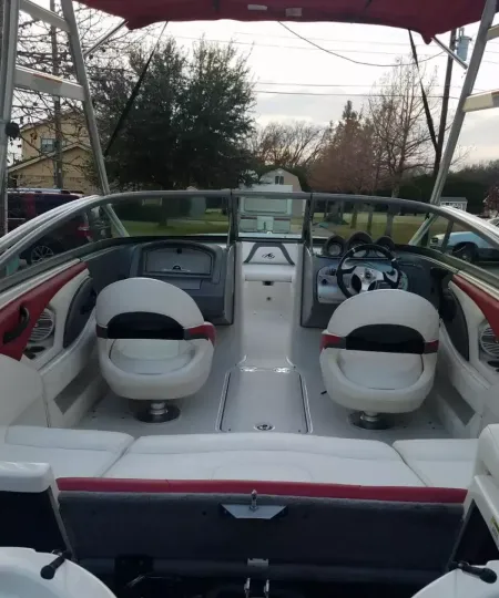 Boat cockpit with clean white and red vinyl seats after interior detailing